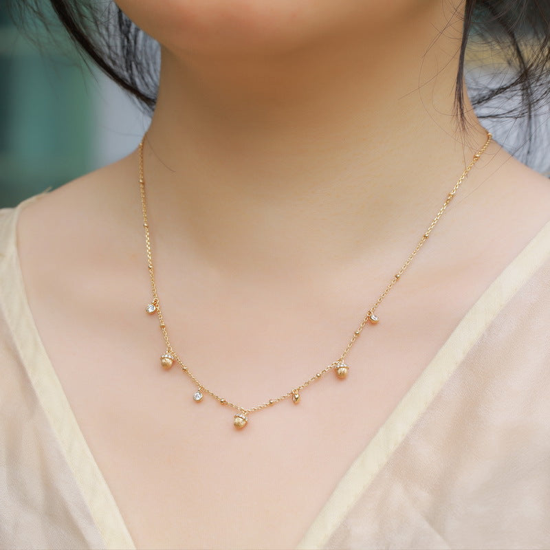 Origsoul delicate necklace in sterling silver with small gold and pearl charm details