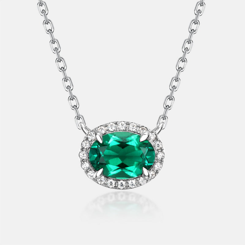 Origsoul sterling silver necklace with an oval emerald green gemstone surrounded by small clear stones