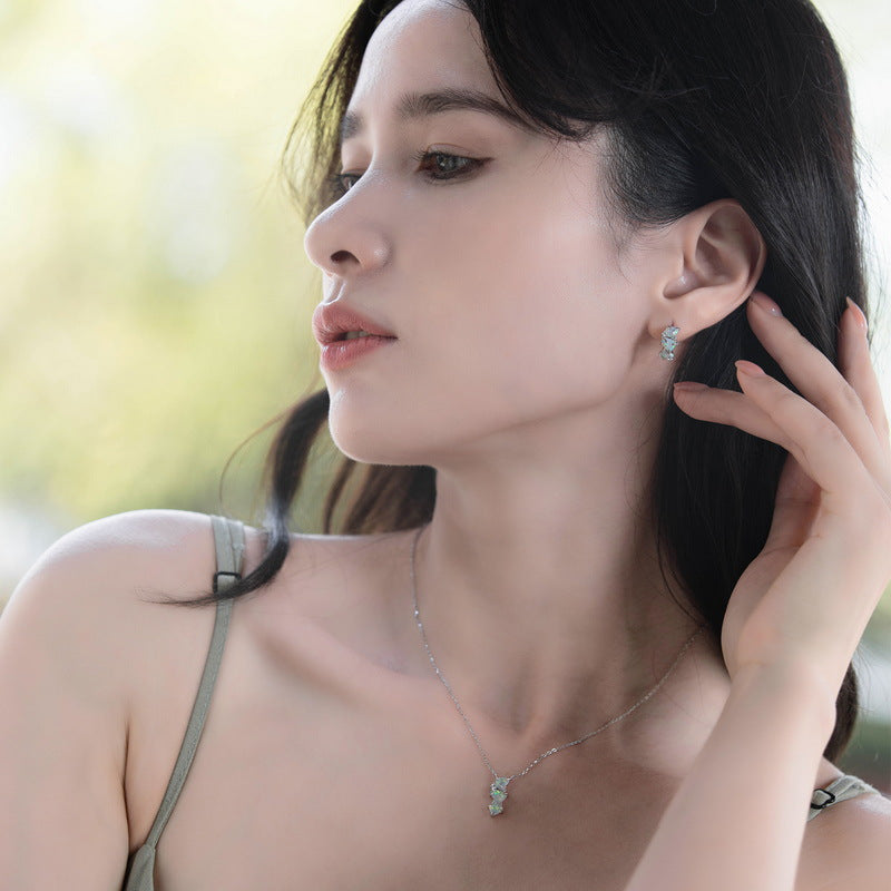 Origsoul sterling silver necklace worn by woman with matching earrings in natural light