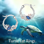 Origsoul sterling silver ocean turtle earrings featuring a design with coral accents