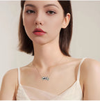 Origsoul sterling silver panda necklace worn by woman in white top with delicate chain and panda pendant