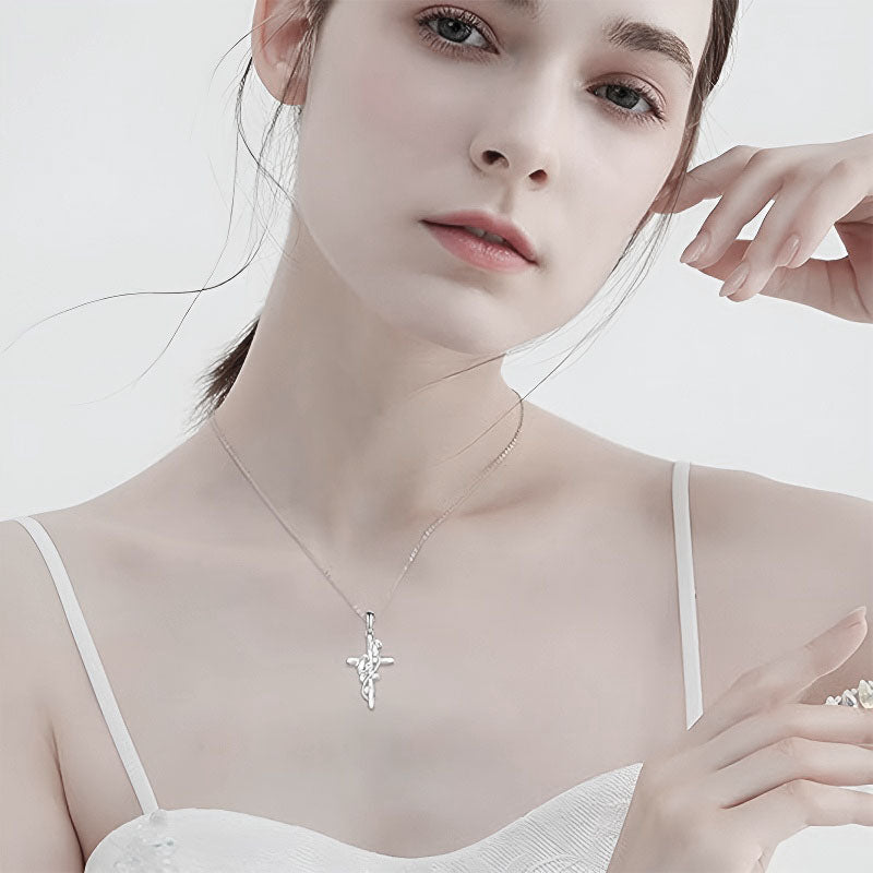 Beautiful model wearing a sterling silver penguin cross necklace that elegantly complements her outfit