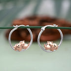 Sterling silver rhino earrings featuring cute rhino designs with rose gold accents