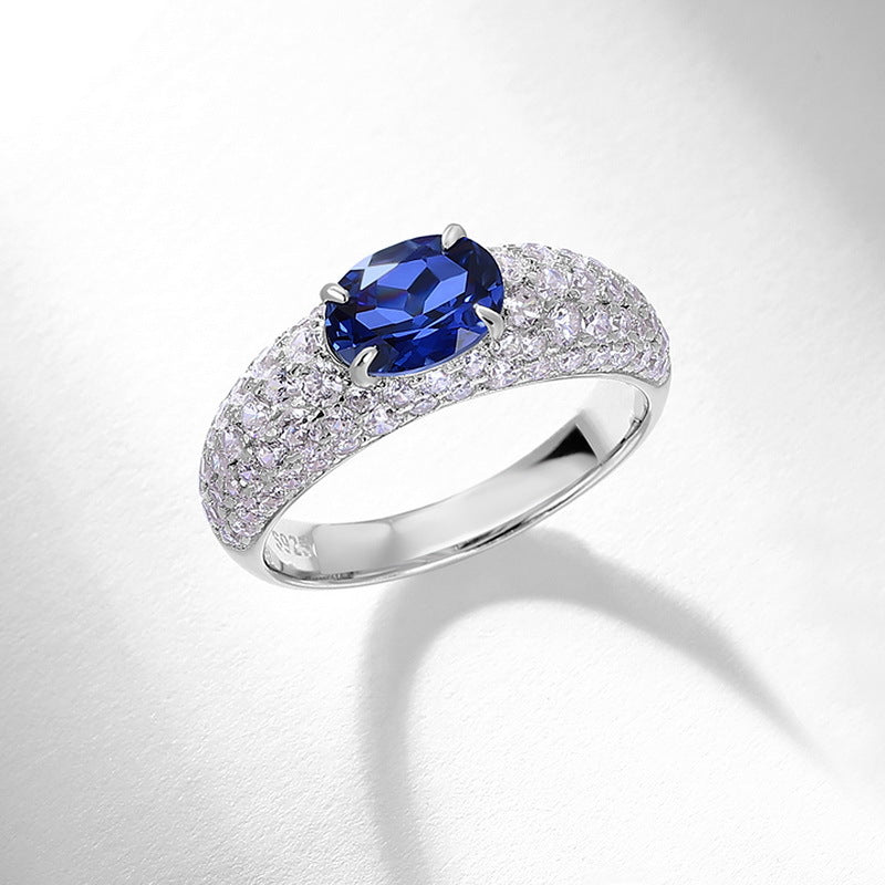 Origsoul sterling silver ring with a large blue oval gemstone and pavé diamond accents