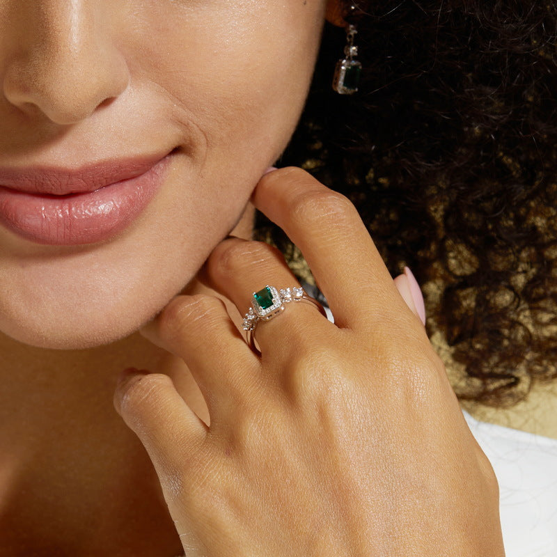 Origsoul sterling silver ring with green gemstone and clear accents worn on finger