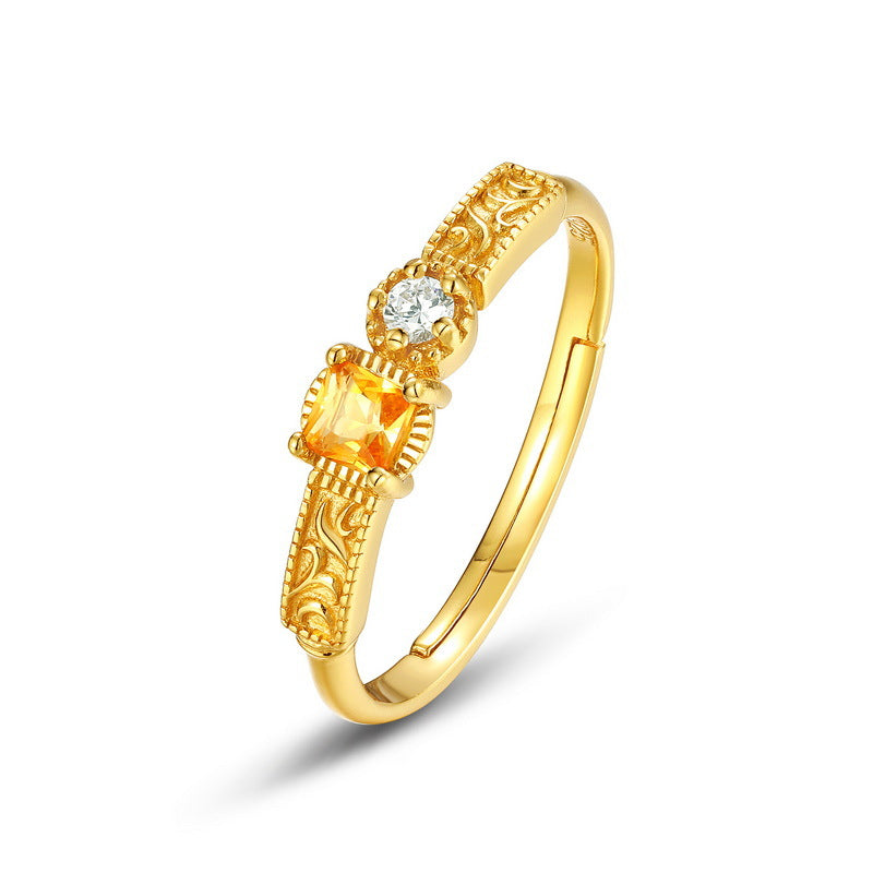 Origsoul gold-tone sterling silver ring with intricate design and two gemstone accents