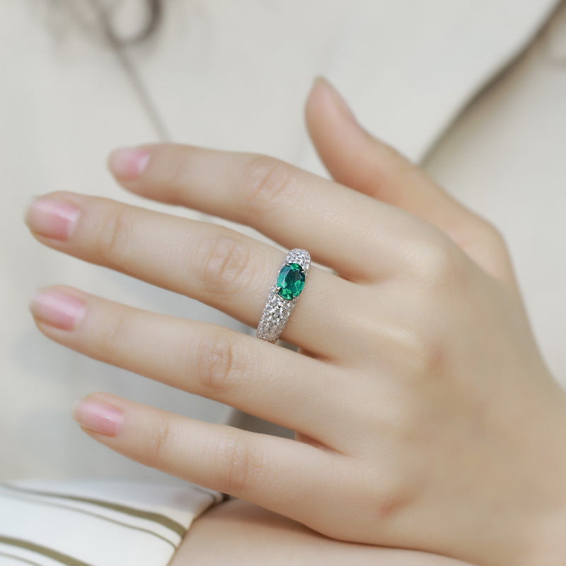 Origsoul sterling silver ring with green oval gemstone and sparkling accents on hand