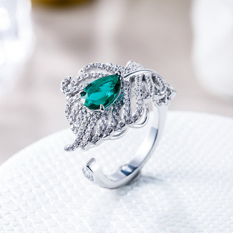 Origsoul sterling silver ring with intricate design and a teardrop shaped green gemstone centerpiece
