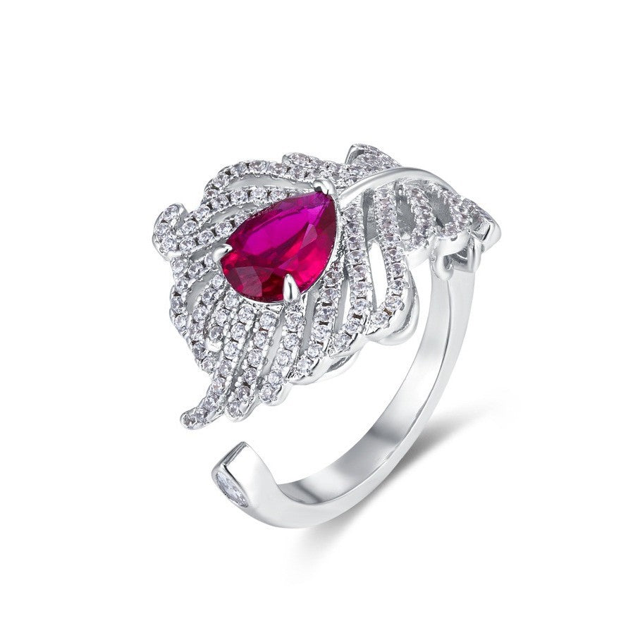 Origsoul sterling silver ring with intricate leaf design and a pear-shaped red gemstone centerpiece