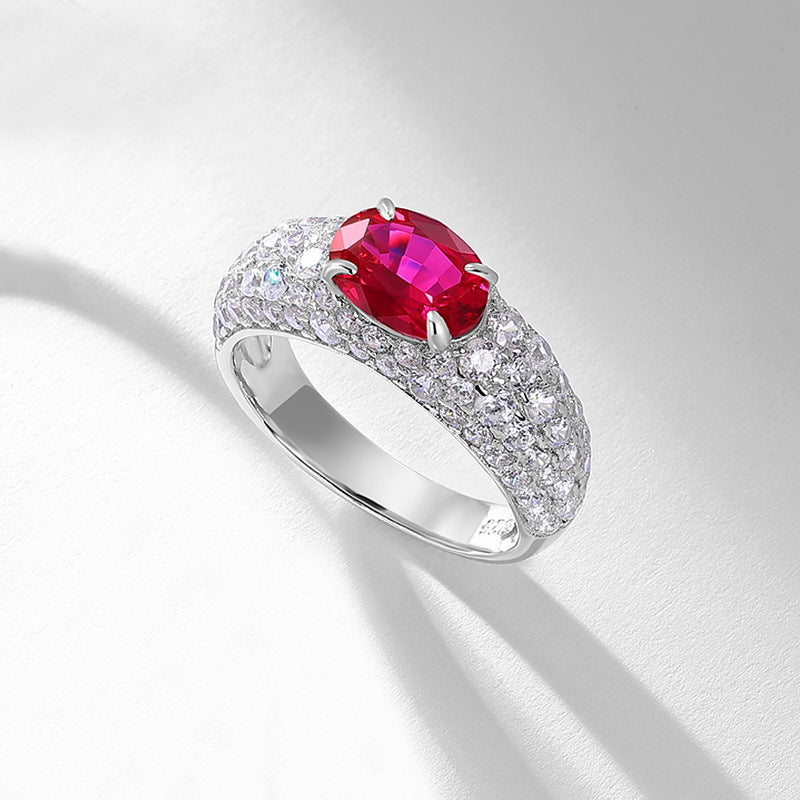 Origsoul sterling silver ring with a large red gemstone and small clear stones encrusted on band