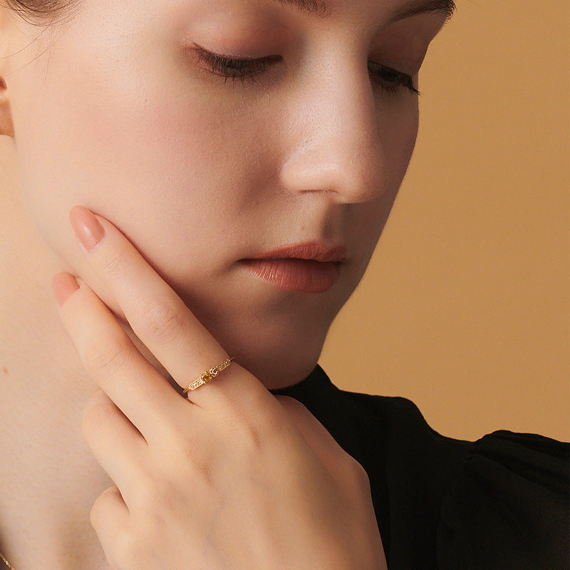Origsoul sterling silver ring worn on finger by woman with neutral makeup and beige background