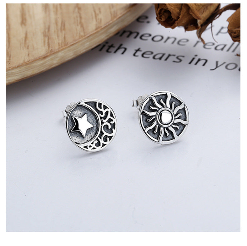 Origsoul sun and moon stud earrings in silver with detailed celestial designs on a white background