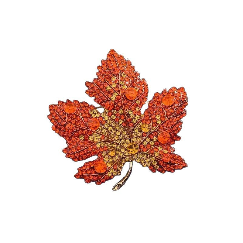 Origsoul decorative brooch in orange and yellow crystals shaped like a toronto maple leaf