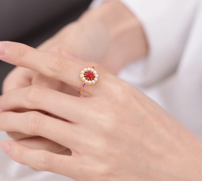 Origsoul unique gemstone jewelry ring with red center stone and pearl halo on finger