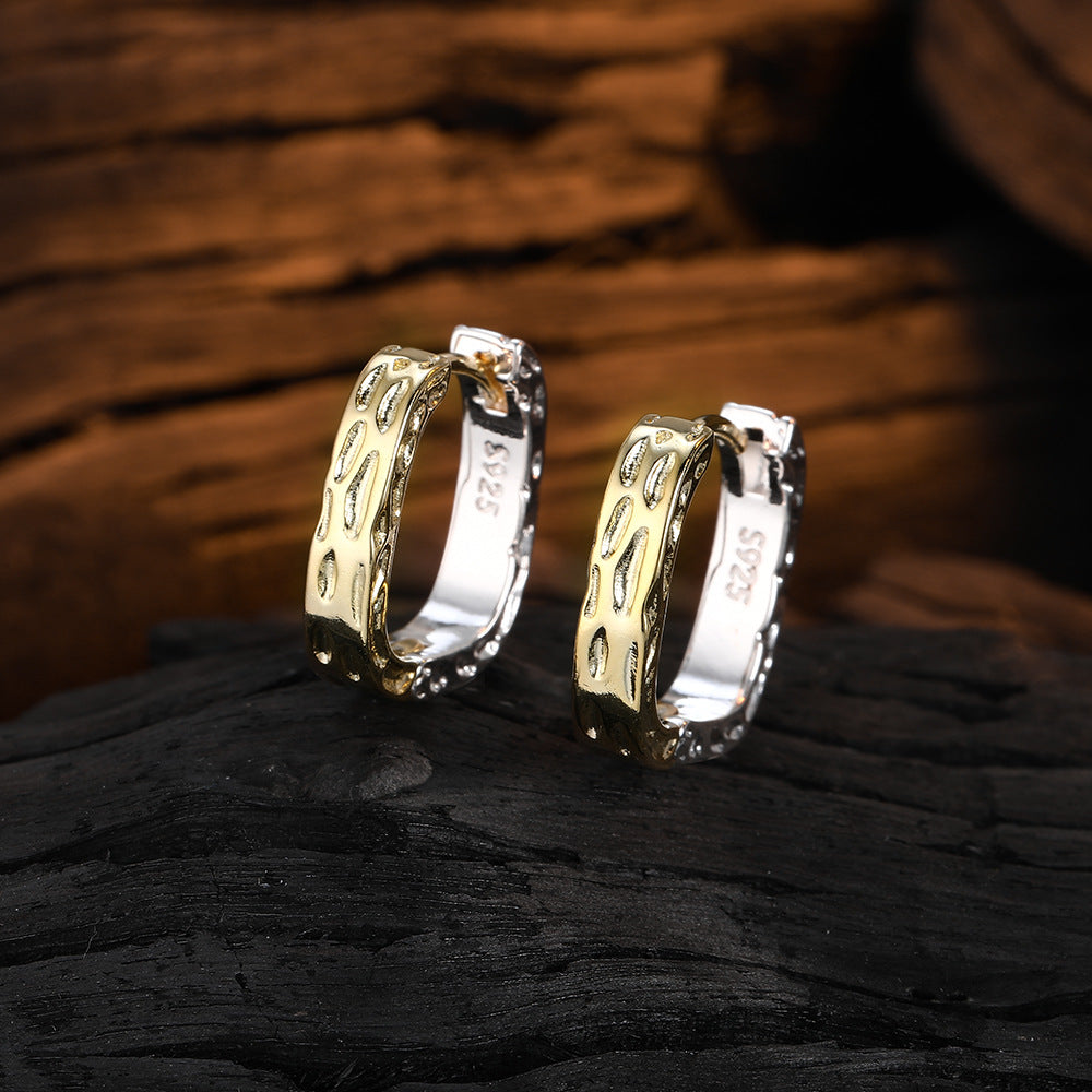 Origsoul unique gold hoop earrings with textured design displayed on dark wood