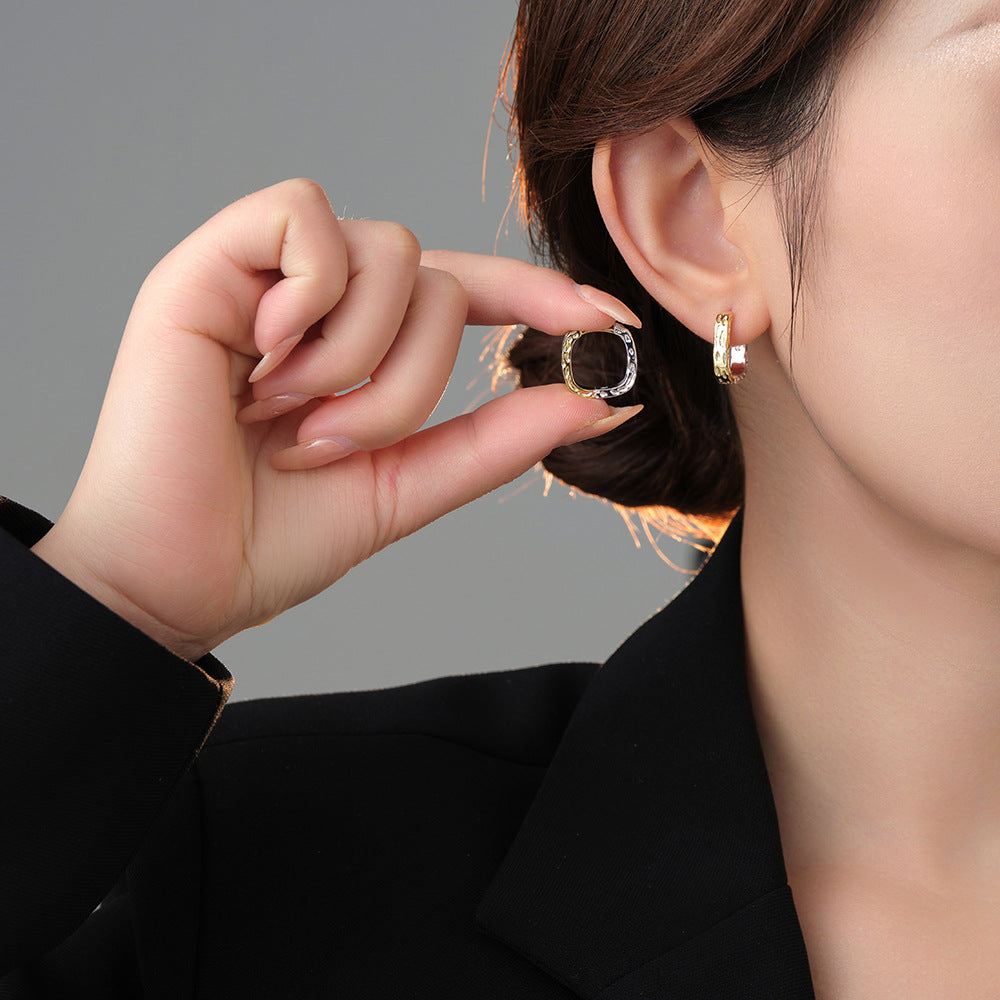 Origsoul unique gold hoop earrings worn on ear and held near face showcasing design