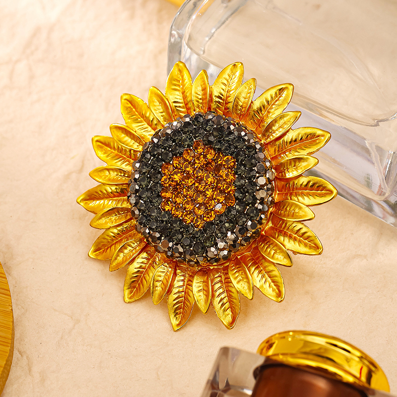 Origsoul Van Gogh sunflower brooch with golden petals and detailed black and orange rhinestones