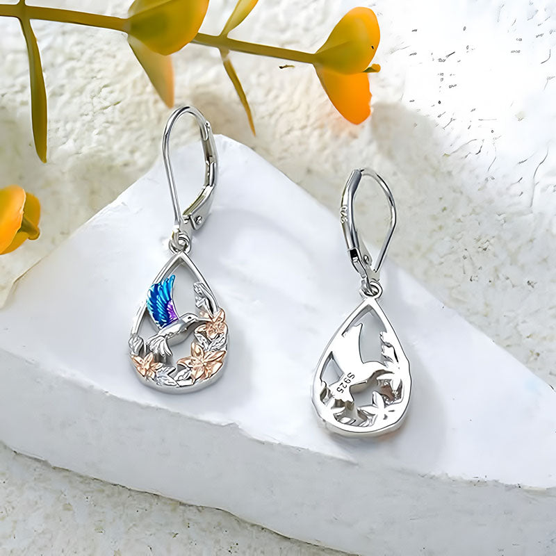 Origsoul handcrafted bird drop earrings with blue and silver bird design and floral accents