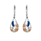 Origsoul handcrafted bird drop earrings with blue and silver hummingbird and gold floral accents