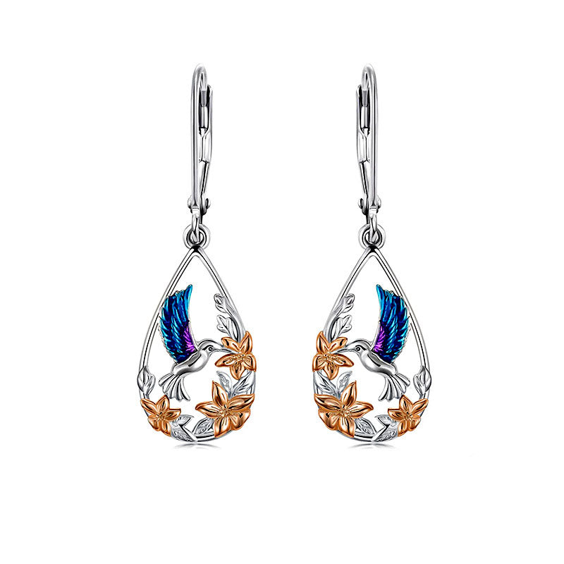 Origsoul handcrafted bird drop earrings with blue and silver hummingbird and gold floral accents