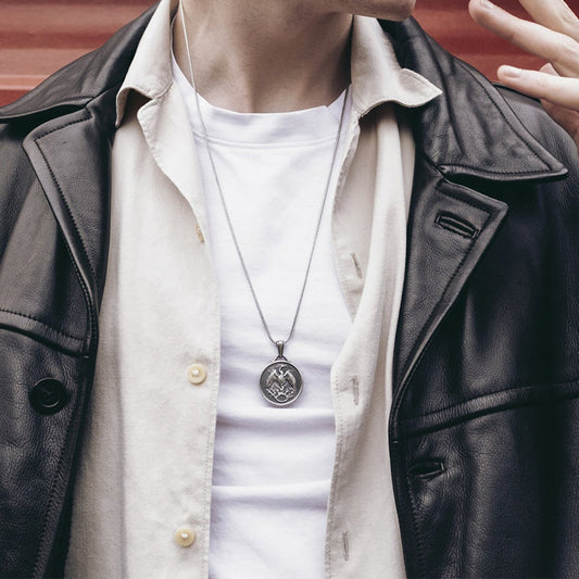 Origsoul phoenix pendant necklace worn over white shirt and beige jacket with black leather coat