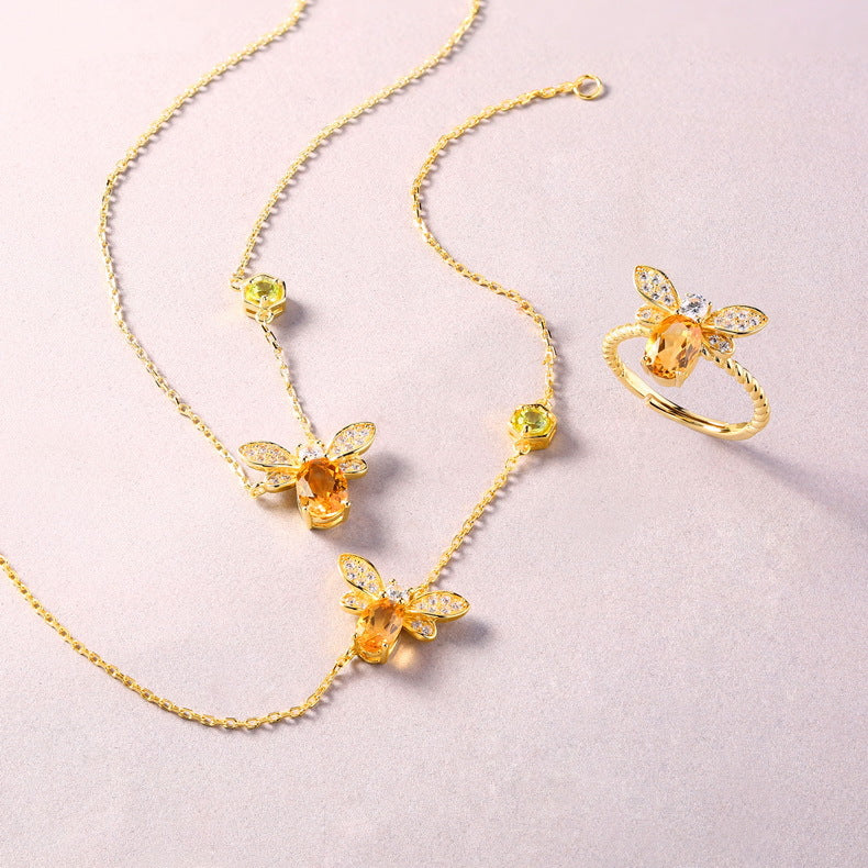 Origsoul silver necklace sterling with gold bee pendant and matching ring set on pink background