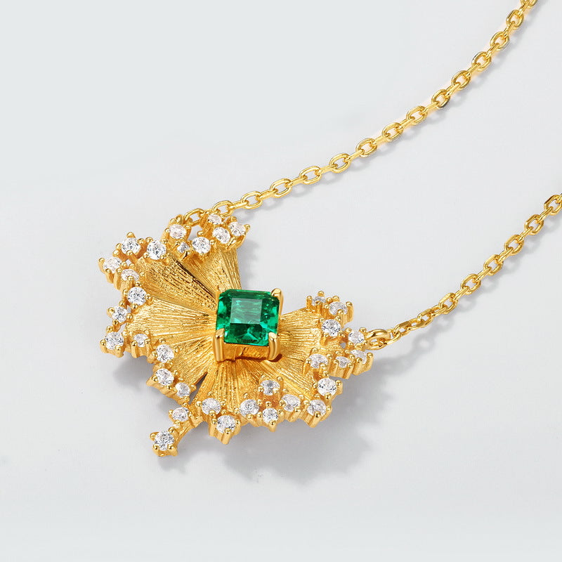 Origsoul gold-plated silver sterling jewelry necklace with emerald green center stone and surrounding clear crystals