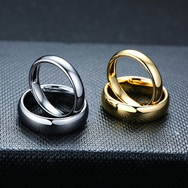 Origsoul smooth matching rings for couples in polished silver and gold on textured black surface