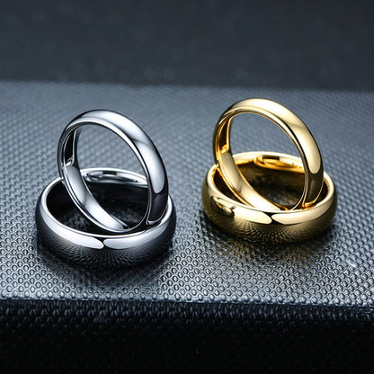 Origsoul smooth matching rings for couples in polished silver and gold on textured black surface
