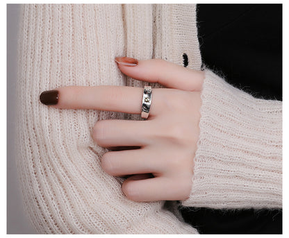 Origsoul cosmic jewelry sun ray ring silver worn on finger with knitted cream sweater background