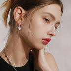 Origsoul whimsical mushroom charm earrings worn by woman with natural makeup and red lipstick