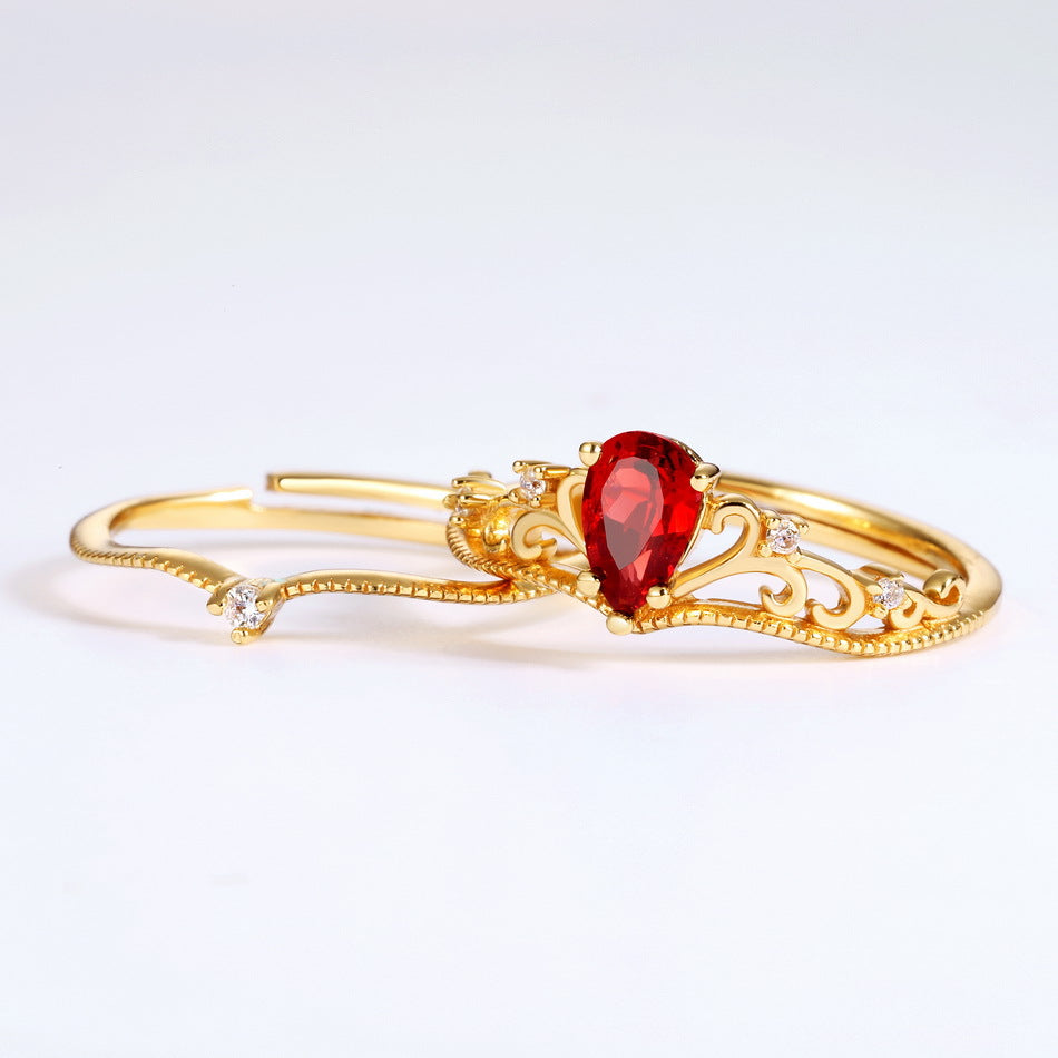 Origsoul vintage engagement ring with pear-shaped red gemstone and intricate gold filigree design