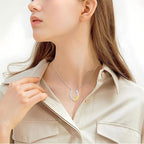Origsoul lucky horseshoe necklace with flower detail worn by woman in beige shirt